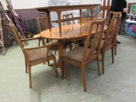 A Nathan extending dining table together with a set of four standard and two carver matching chairs,