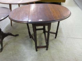 An early 20th century oak gate leg table