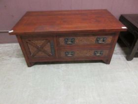 A stained oak coffee table with two drawers flanked by cupboard door