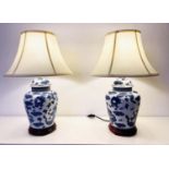 TABLE LAMPS, a pair, Chinese export style blue and white ceramic with dragon design, with shades. (