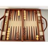 BACKGAMMON SET, in leathered case 7cm x 23cm x 40cm.