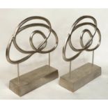 SCULPTURES, a pair, silvered metal on stands, 76cm H x 70cm W. (2)