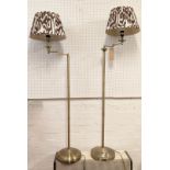 LIBRARY LAMPS, a near pair brushed brass with swing arms and Melodi Horne ikat chocolate deco
