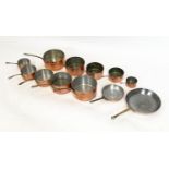 BATTERIE DE CUISINE, comprising of two sets of five graduated copper pans and two frying pans. (12)