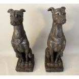 SCULPTURAL HOUNDS, a pair, 78cm high, 23cm wide, 26cm deep, resin in a faux bronze finish. (2)