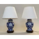 TABLE LAMPS, a pair, Chinese blue and white ceramic of vase form with carved wooden bases and