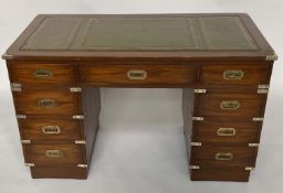 CAMPAIGN STYLE DESK, mahogany and brass bound with nine drawers, twin pedestals and gilt tooled