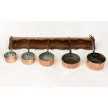 BATTERIE DE CUISINE, copper pans, a set of five graduated pots and oak wall hanging rack, 26cm H x