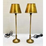 LIBRARY LAMPS, 64cm high, 20cm diameter, gilt shades and stands. (2)