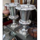 URNS, a pair, polished metal, each 84cm H x 53cm W. (2)