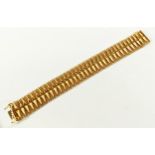 AN ITALIAN 18CT GOLD BRACELET, spike motif on a chain-link back, 21cm long, 55.9 grams.