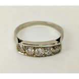 A FIVE STONE DIAMOND RING, tests as white gold, the channel set stones of graduated size, the