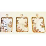 WALL MIRRORS, a set of three, gilt metal frames, floral decoration to plate, 64cm x 40cm. (3)