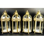 STORM LANTERNS, a set of four, 46cm high, 19cm diameter, Regency style, gilt metal, glazed sides. (