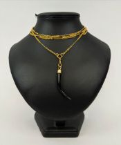 AN 18CT GOLD ALBERT CHAIN, with a ebony tusk pendant, 142 cm / 56 inches long, total gold weight, 35