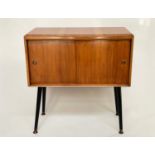CABINET, 1950s walnut with two sliding doors and splayed brass tipped ebonised supports, 74cm W x