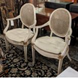 OPEN ARMCHAIRS, a pair, each 63cm W, Hepplewhite style with caned backs and seats and squab cushions