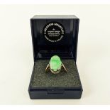 AN 18CT GOLD AND JADE SET DRESS RING, the single jade cabouchon in a white metal pierced setting,