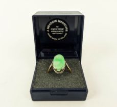 AN 18CT GOLD AND JADE SET DRESS RING, the single jade cabouchon in a white metal pierced setting,