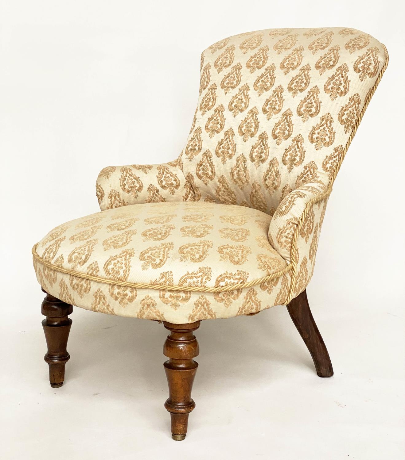 SLIPPER ARMCHAIR, Victorian walnut with two tone woven leaf upholstery and turned front supports,