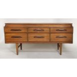 LOW CHEST, 1970s teak with six short drawers and tapering supports, 150cm W x 50cm D x 70cm H.