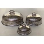 DINNER DOME/COVERS, a graduated set of three early 20th century silver plated and engraved monogram,