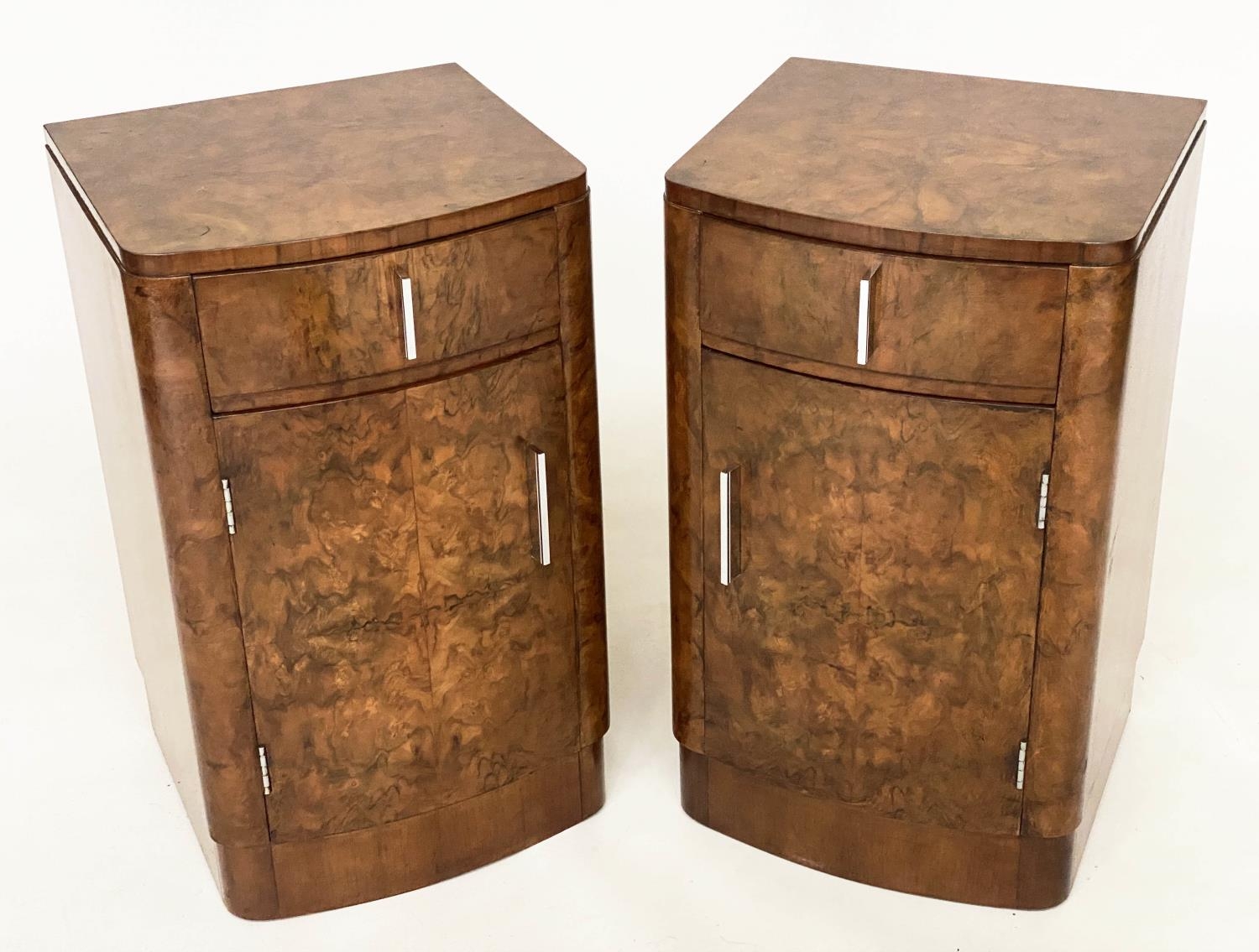 BEDSIDE CABINETS, a pair, Art Deco period burr walnut of bowed outline each with drawer and door,