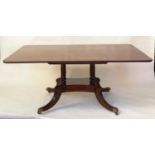 DINING TABLE, Regency period rounded rectangular figured mahogany raised upon four pillar outswept