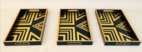 COCKTAIL TRAYS, a set of 3, black and gold art deco style design, 5cm x 40cm x 25cm.