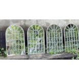 ARCHITECTURAL GARDEN MIRRORS, a set of 4, arched top aged metal frames, 60cm x 36cm.