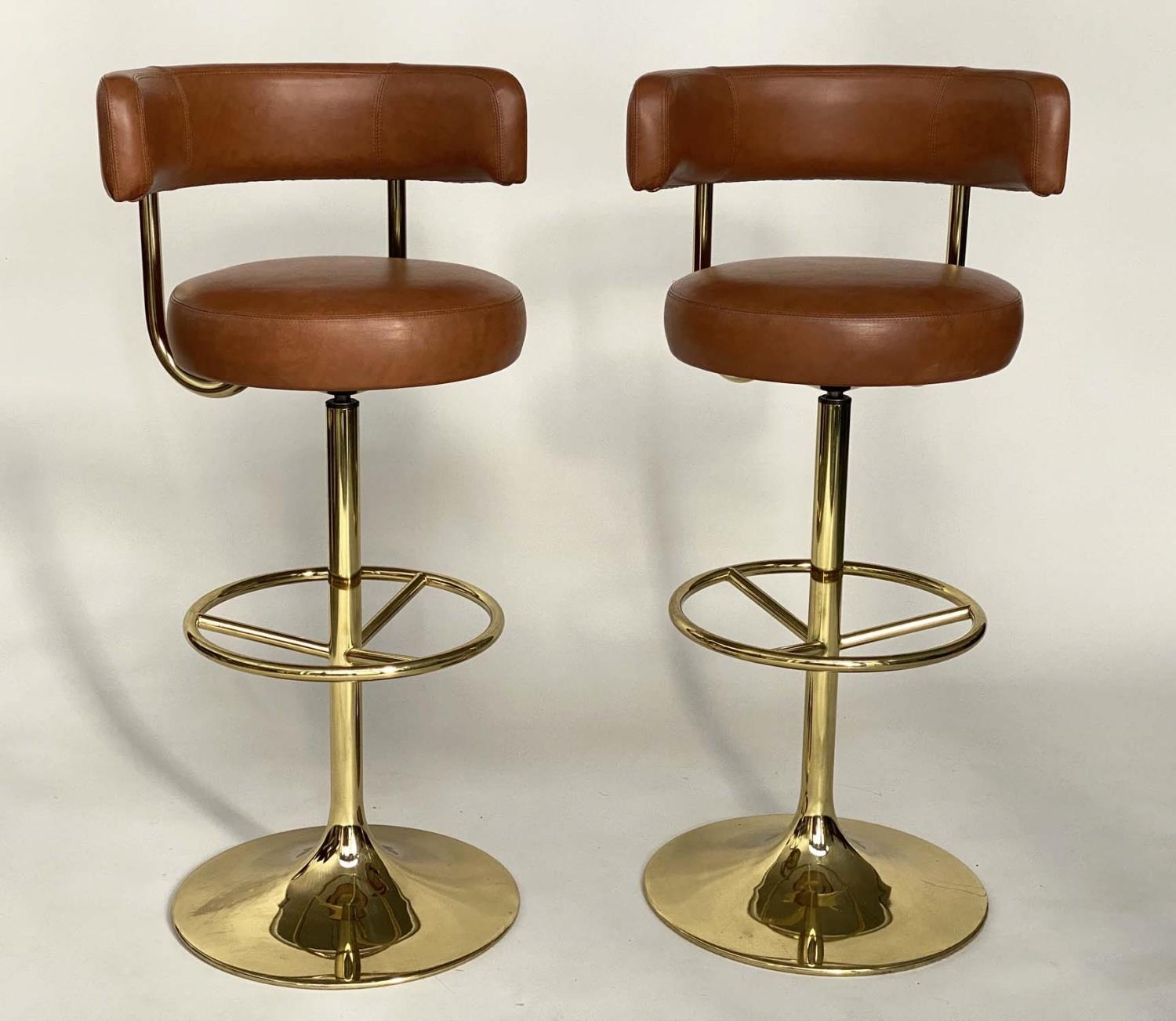 JOHANSON DESIGN SWEDISH BAR STOOLS, a pair, with leather back and seat and gilt brass support, 107cm