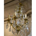 CHANDELIER, approx 78cm H x 55cm W, brass with glass drops and six lights.