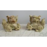 JADIETE TEMPLE LIONS, a pair, each with paw resting on ball, 20cm x 20cm H. (2)