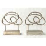 SCULPTURES, a pair, silvered metal on stands, 76cm H x 70cm W. (2)