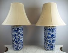 LAMPS, a pair, Chinese foliate blue and white decoration, hexagonal form with silk shades, 87cm