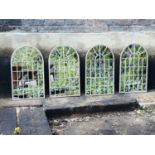 GEORGIAN STYLE GARDEN MIRRORS, set of four, each measuring 60cm high, 36cm wide, arched metal