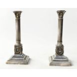 CANDLESTICKS, a pair, 19th century silvered Corinthian capped, reeded column, wreath stepped