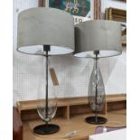 TABLE LAMPS, a pair, grey shades, glass bases of ovoid form, black metal circular bases, 77cm H. (2)