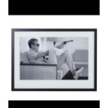 AFTER JOHN DOWNING, Steve McQueen with a gun, photographic print, framed and glazed, 54cm x 74cm.