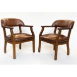 LIBRARY ARMCHAIRS, a pair, walnut and studded mid tan leather each with curved back, 62cm W. (2)