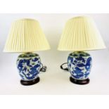 TABLE LAMPS, a pair, 53cm high, 38cm diameter, Chinese export style, blue and white, with shades,