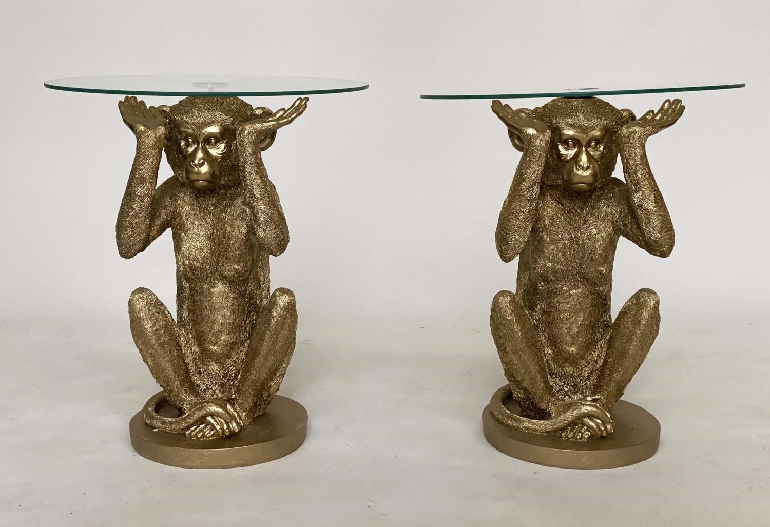 MONKEY MARTINI TABLES, a pair, each with glass top supported by monkey base, 50cm H x 43cm. (2)