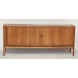 SIDEBOARD, mid 20th century teak, with tambour sliding front enclosing four shelves and four sliding