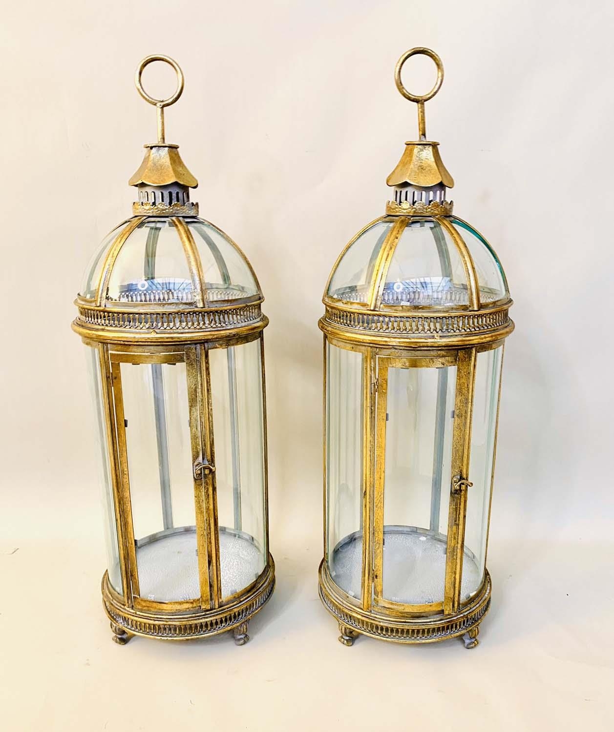 STORM LANTERNS, pair, 80cm H x 28cm diam., Regency style, curved glazed sides and gilt metal frames.