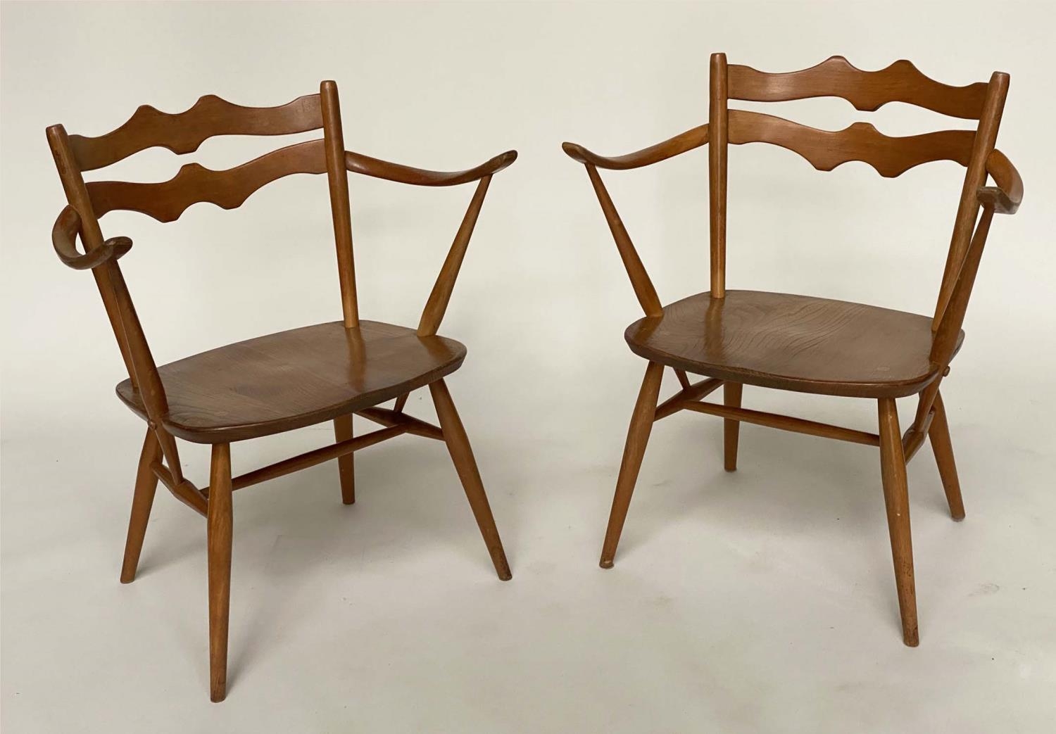 ERCOL EASY ARMCHAIRS, a pair, elm with wave back and outswept arms, 64cm. (2)