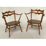 ERCOL EASY ARMCHAIRS, a pair, elm with wave back and outswept arms, 64cm. (2)