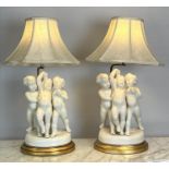 TABLE LAMPS, a pair, blanc de chine porcelain putti on giltwood bases, with shades, 66cm H. (2)