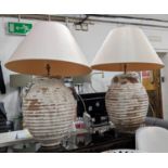 TABLE LAMPS, a pair, aged painted terracotta, with shades 100cm H. (2)