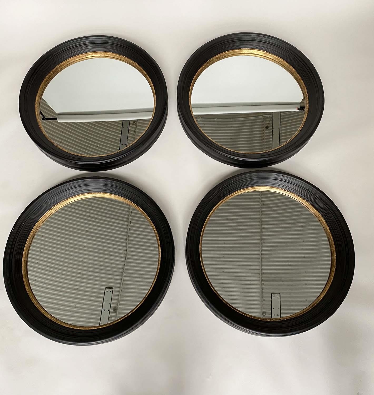 BUTLER STYLE WALL MIRRORS, a set of four Regency style, circular ebonised and gilt each 95cm W. (4)