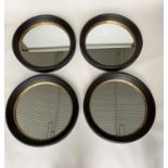 BUTLER STYLE WALL MIRRORS, a set of four Regency style, circular ebonised and gilt each 95cm W. (4)